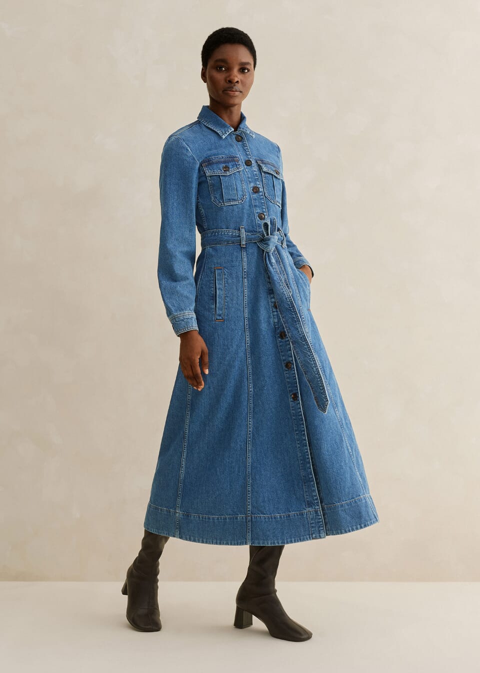 This Me + Em  denim midi dress is a versatile autumn investment, this denim dress is shaped to a midi length and features a line of buttons through the centre to adjust the neckline and accommodate base layers when temperatures start to drop.